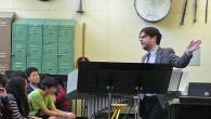 Richard Russell emcees a presentation at Bronx Science HS.